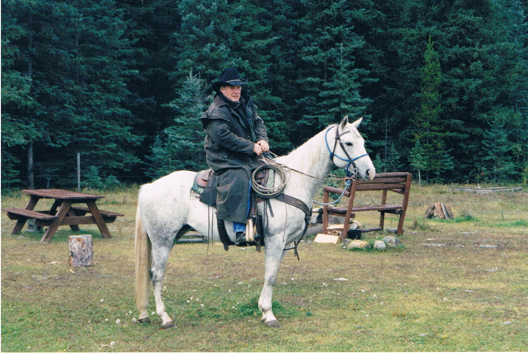 Darryl on a white horse at the Barrier Mountain Outfitters grounds